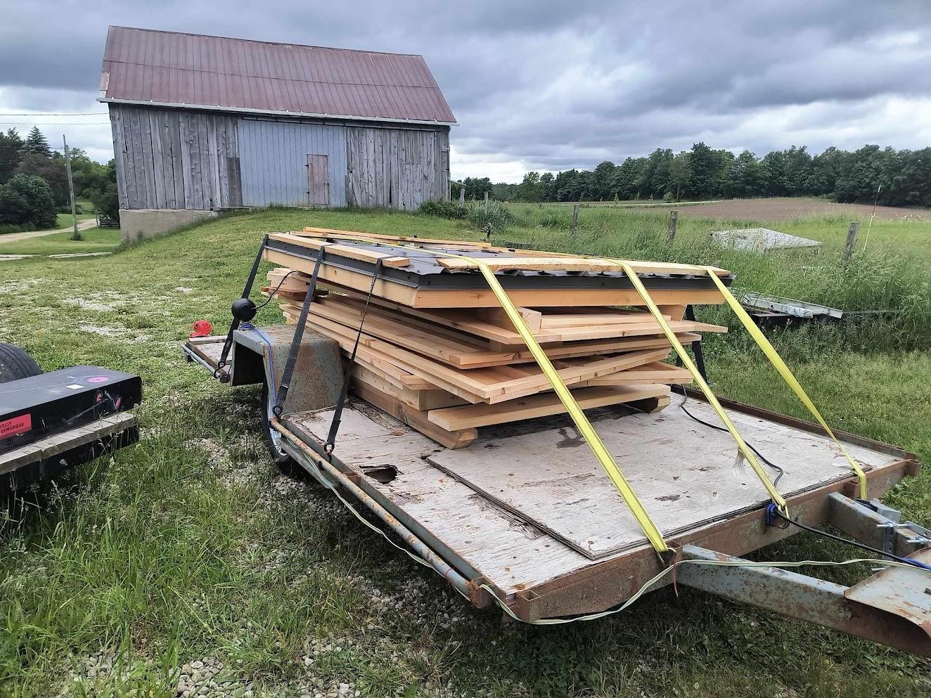 Flat pack cedar outhouse panels loaded on a flatbed trailer ready for customer pickup in Ontario